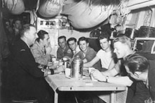 Chief of the Naval Staff, Vice- Admiral Rollo Mainguy, shares a coffee in the seamen’s mess of Athabaskan while visiting the ship in Korean waters, February 1953.