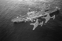 The sea-based fighter air defence of the fleet, as provided by these Banshees flying over Bonaventure, would prove too costly to maintain, and both aircraft and carrier would be scrapped by the end of the decade.