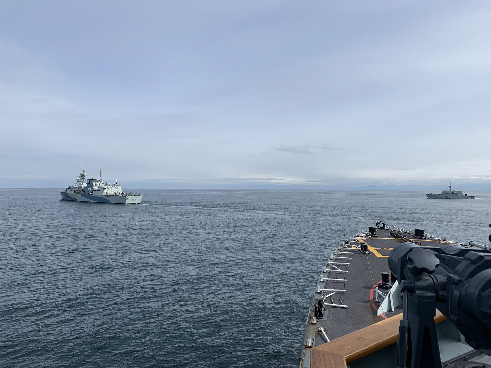 HMCS Calgary takes station on HMCS Regina as HMCS Brandon also manoeuvres into position for a Replenishment at Sea (RAS) Approaches exercise. The ships  are currently participating in Task Group Exercise (TGEX) 20-1 off the coast of Vancouver Island, supporting HMCS Calgary as it conduct High Readiness Work Ups in preparation for a deployment to the Asia-Pacific later this Spring.
