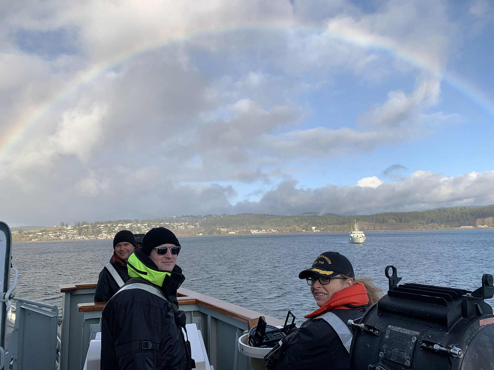 Commander of HMCS Brandon and her crew stand out on the bridge as a rainbow appears overhead as they participated in high readiness work ups off the coast of Victoria BC last week.  