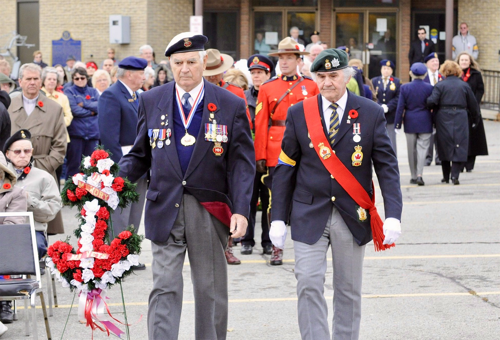 Mr. Wetherall (left) lays a wreath at a modern-era Remembrance Day ceremony.

